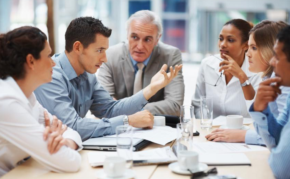 Group of 6 individuals collaborating in a meeting