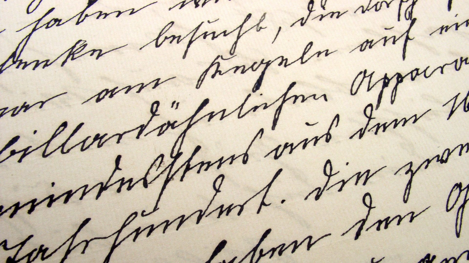 Close up picture of cursive handwriting on white paper