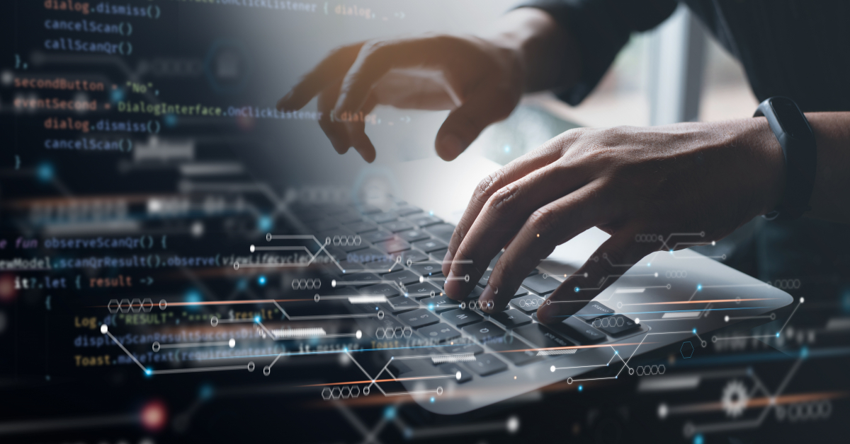 Picture of hands typing on a keyboard with digital coding imagery overlayed on top.