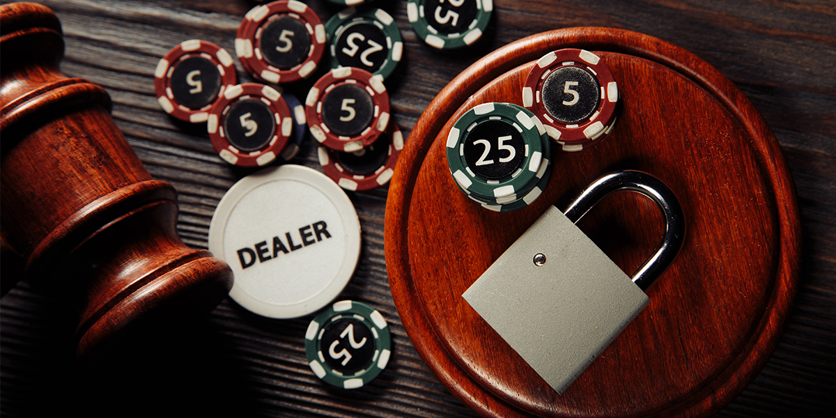 Using Customer Due Diligence (CDD) to prevent fraud in Casinos. Image of poker chips with a padlock and gavel.